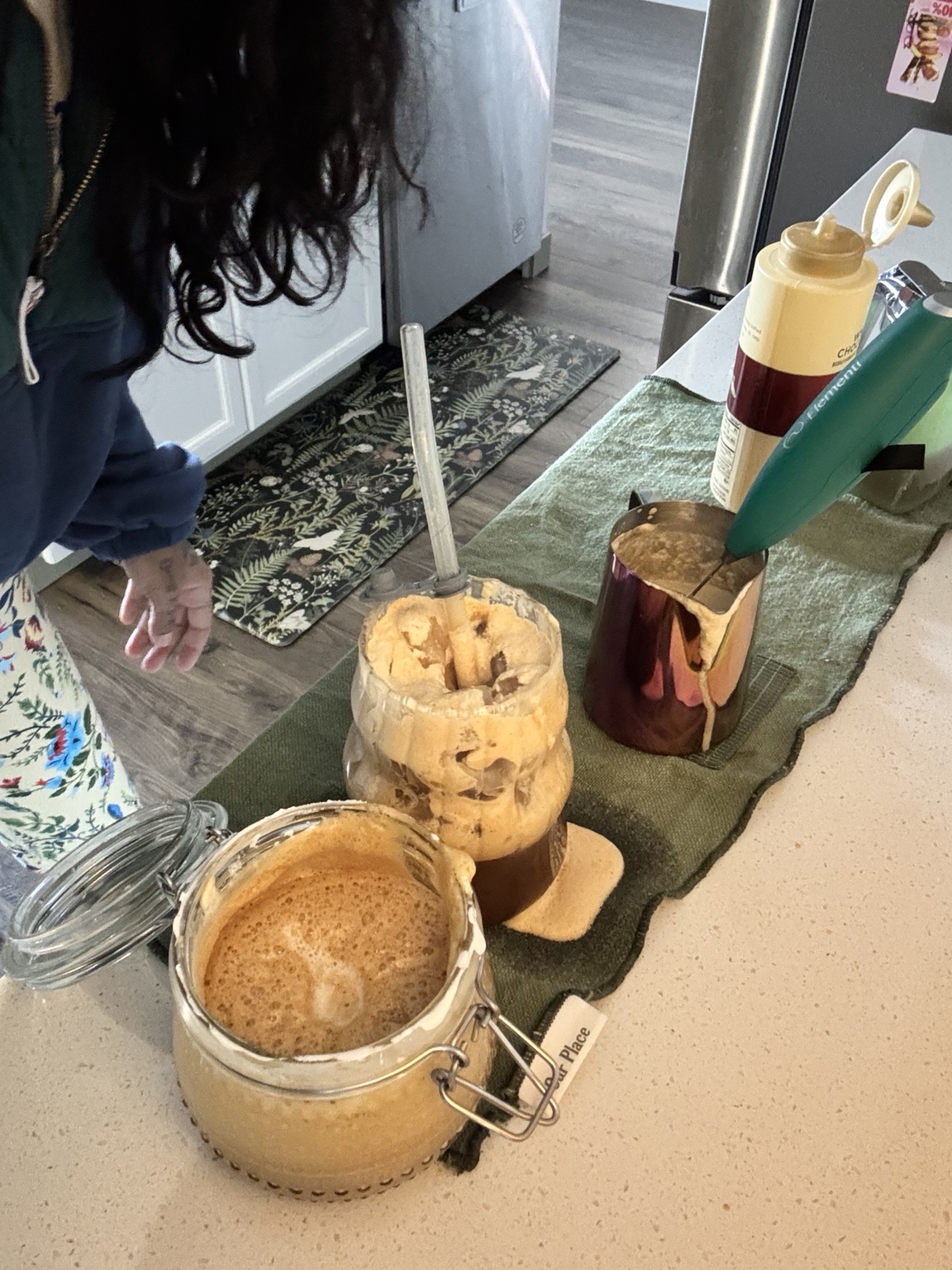 Michelle’s real Friday coffee: golden foam, an iced glass and a rose-gold frothing pitcher.